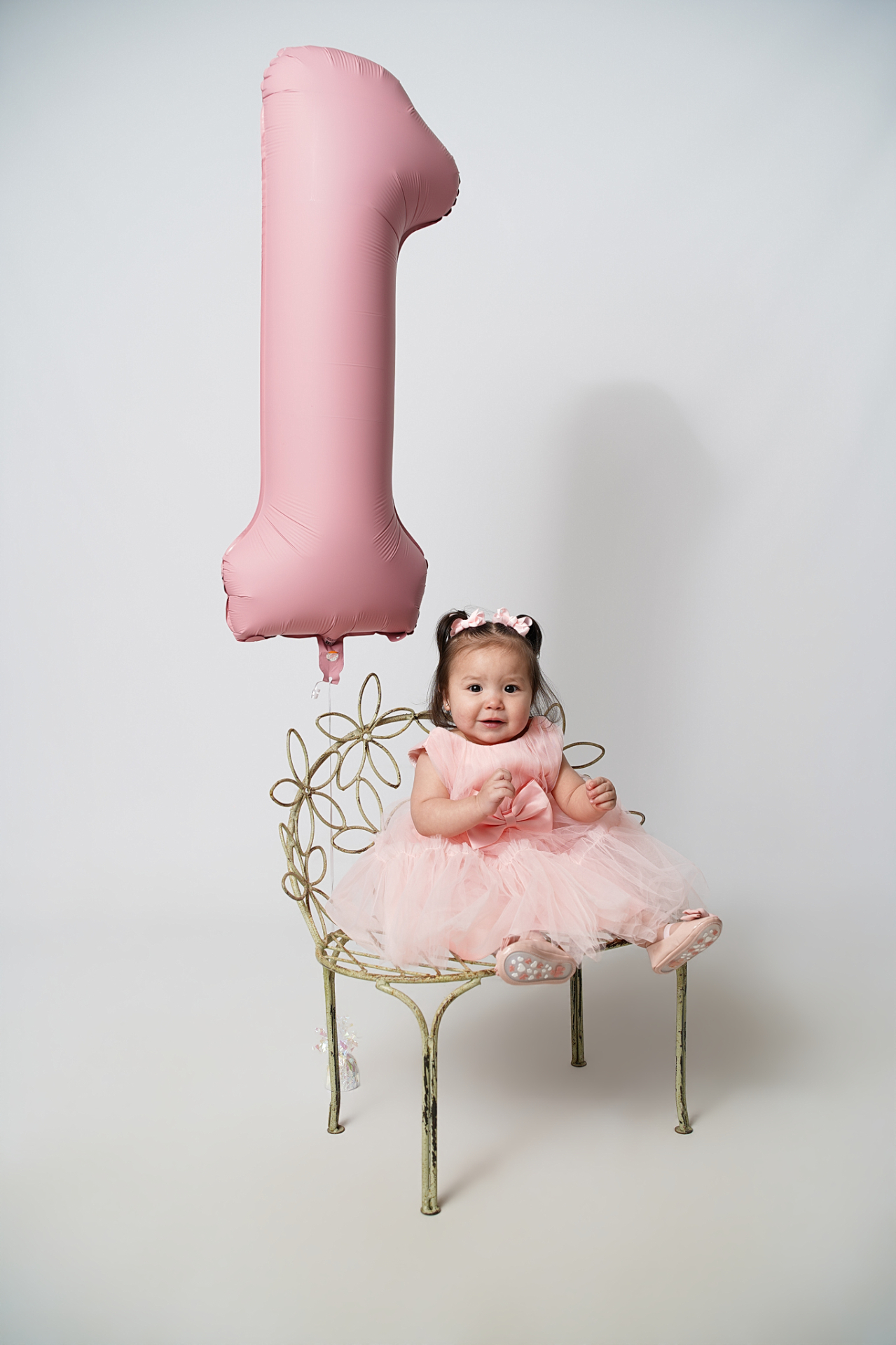First birthday portrait with pink balloon and floral chair