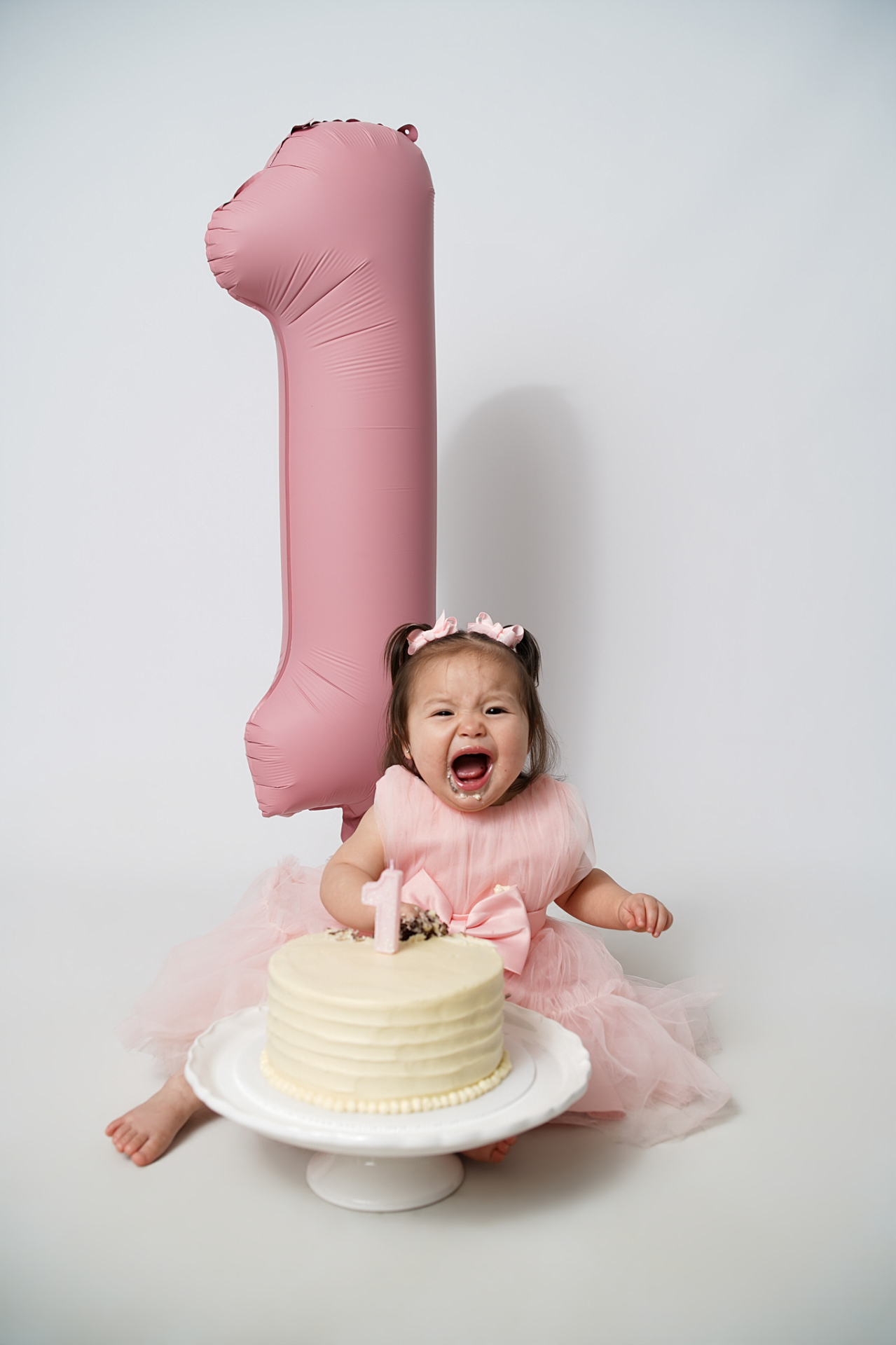 Candid cake smash laughter — first birthday celebration